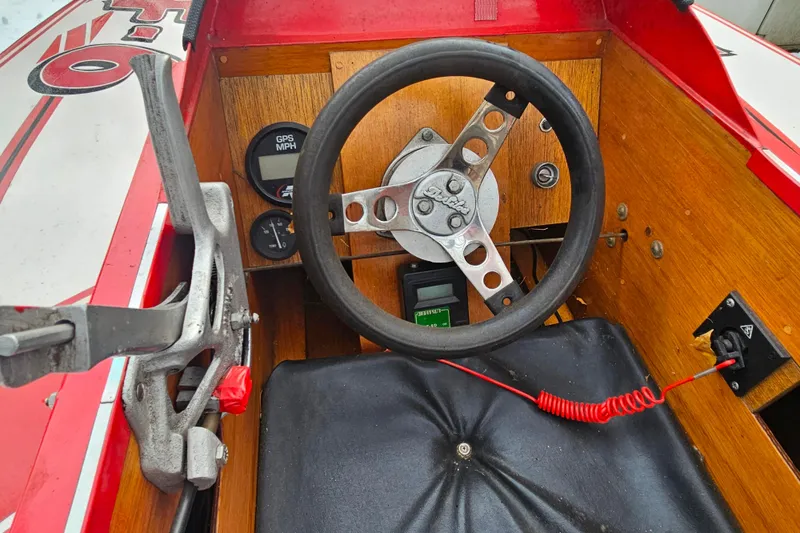 Slide: The Image of Interior of a 1987 De Silva F Class Race boat with wooden dashboard and steering wheel. - 11