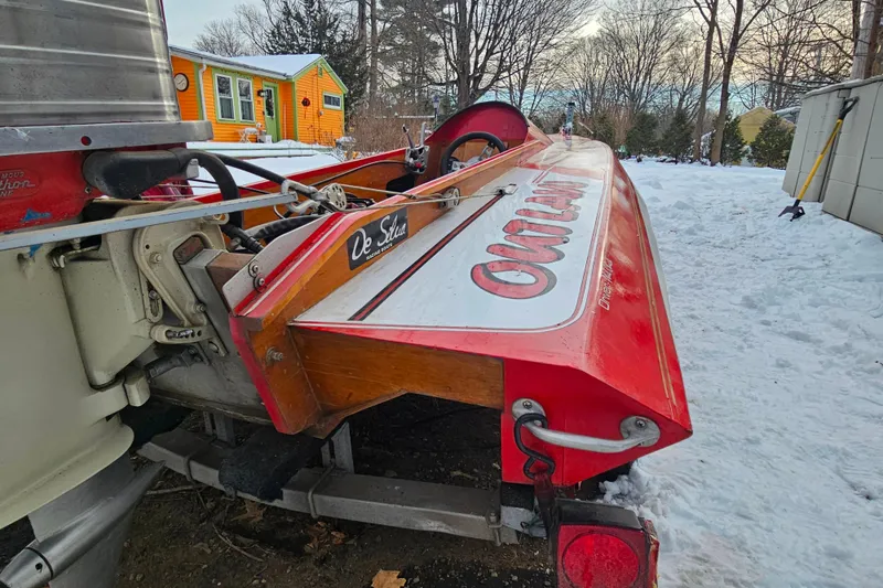 Slide: The Image of 1987 De Silva F Class Race boat in snowy yard, vibrant orange house in background. - 15