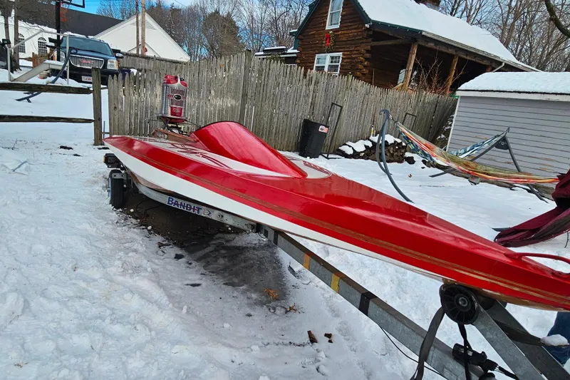 Slide: The Image of Red 1987 De Silva F Class Race boat on trailer in snowy yard. - 21