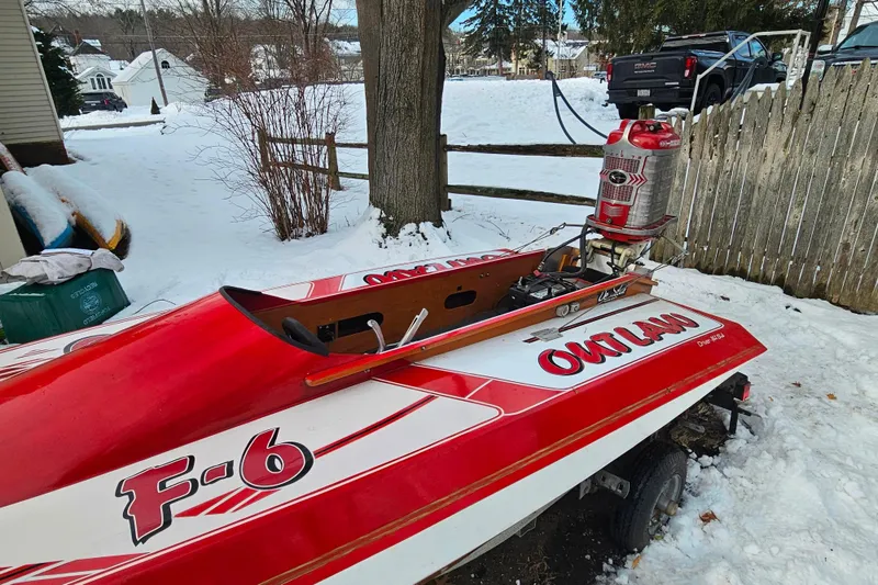 Slide: The Image of Red 1987 De Silva F Class Race boat in snowy yard, labeled "Outlaw." - 24
