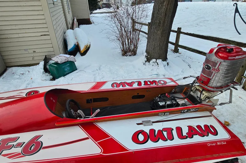 Slide: The Image of 1987 De Silva F Class Race boat, red and white, parked in snowy yard. - 27