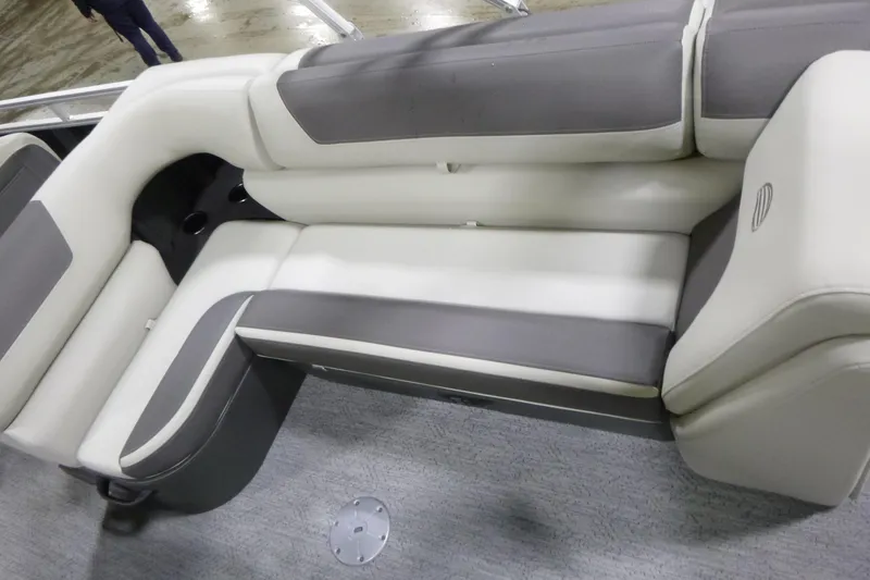 Slide: The Image of 2026 Sun Tracker Fishin' Barge 22 DLX interior seating, featuring gray and white cushioned seats. - 10