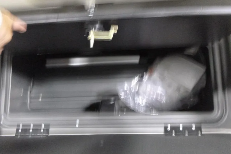 Slide: The Image of Storage compartment of 2026 Sun Tracker Fishin' Barge 22 DLX boat, partially open. - 11