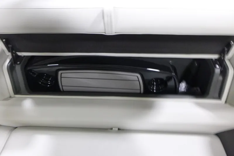 Slide: The Image of 2026 Sun Tracker Fishin' Barge 22 DLX storage compartment with sleek interior design. - 12