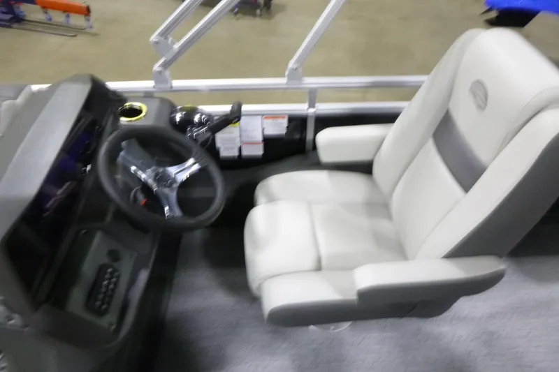 Slide: The Image of Captain's chair and steering console of 2026 Sun Tracker Fishin' Barge 22 DLX pontoon boat. - 13