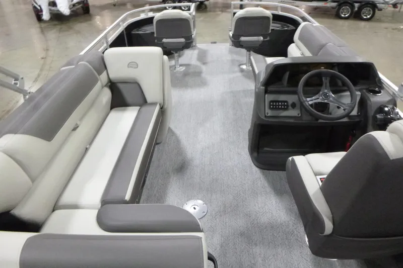 Slide: The Image of 2026 Sun Tracker Fishin' Barge 22 DLX interior with seating and steering console. - 5