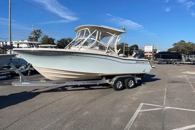 The Image of 2022 Grady-White Freedom 235 boat on trailer in parking lot, clear sky background. - 1