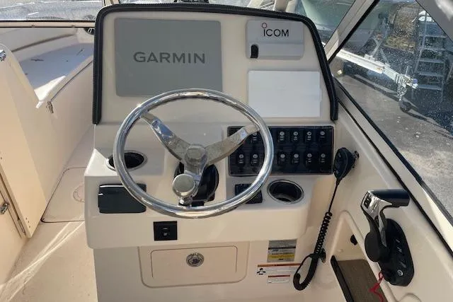 Slide: The Image of 2022 Grady-White Freedom 235 boat dashboard with Garmin and Icom equipment. - 12