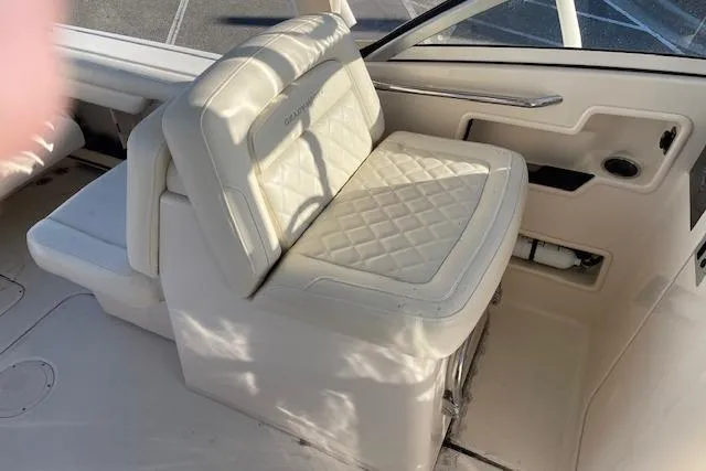 Slide: The Image of 2022 Grady-White Freedom 235 boat interior with cushioned seating and sleek design. - 15