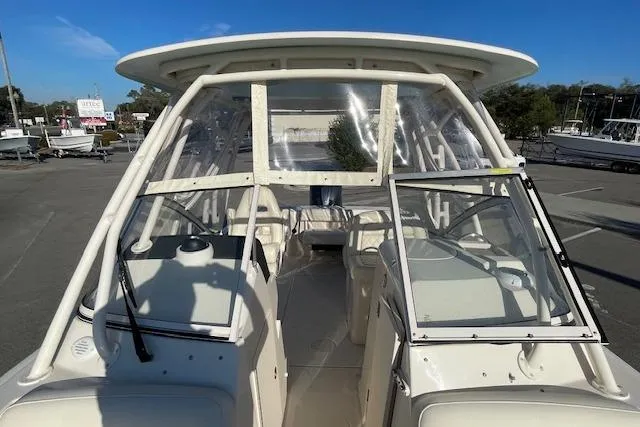 Slide: The Image of 2022 Grady-White Freedom 235 boat with open windshield, parked outdoors. - 21