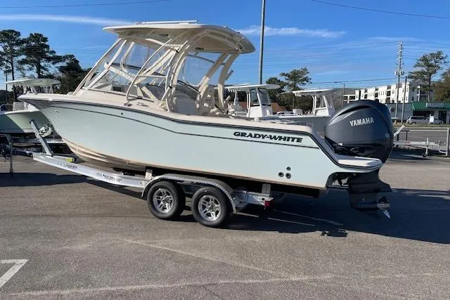 Slide: The Image of 2022 Grady-White Freedom 235 boat on trailer with Yamaha engine in parking lot. - 4
