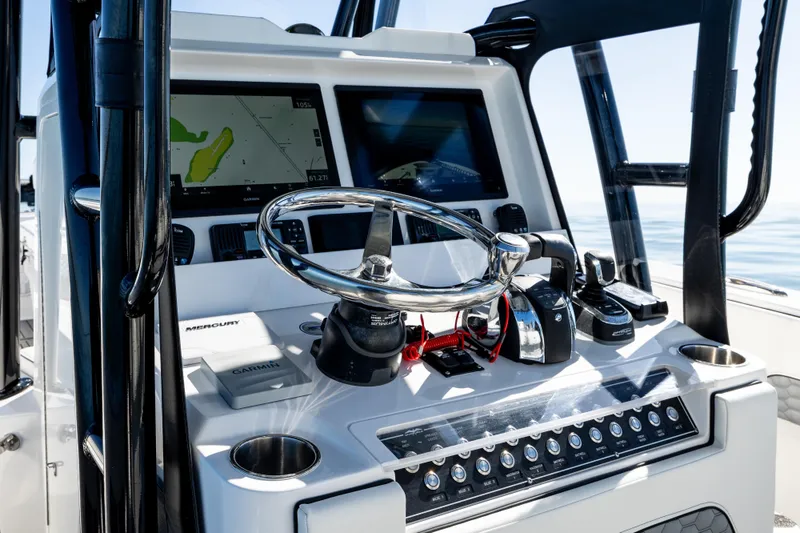 Slide: The Image of 2022 Invincible 33 Open Fisherman boat dashboard with navigation screens and controls. - 10