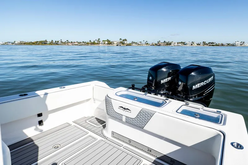 Slide: The Image of 2022 Invincible 33 Open Fisherman boat with twin Mercury engines on calm water. - 14