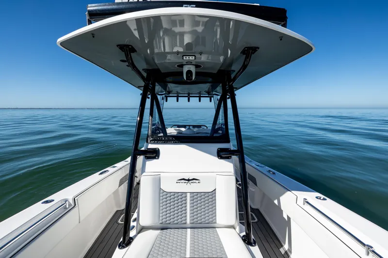 Slide: The Image of 2022 Invincible 33 Open Fisherman boat on calm ocean waters under clear blue sky. - 18