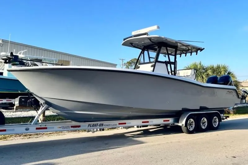 Slide: The Image of 2022 Invincible 33 Open Fisherman boat on trailer, parked outdoors. - 9