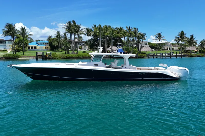 The Image of 2020 HCB 53 Sueños boat cruising on clear blue water near palm trees. - 0