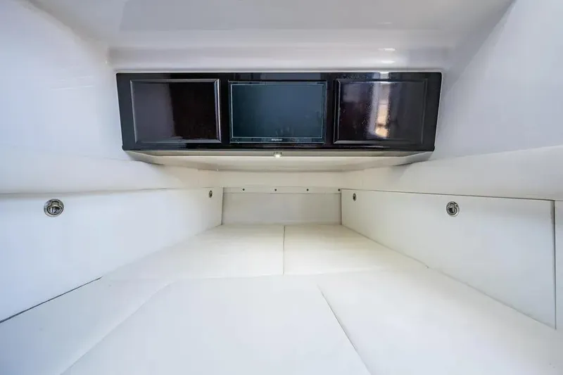 Slide: The Image of Interior cabin of 2020 HCB 53 Sueños boat, featuring sleek white design and storage compartments. - 21