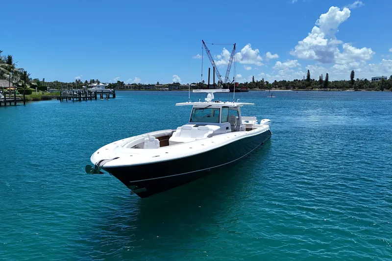 Slide: The Image of 2020 HCB 53 Sueños boat on clear blue water under a sunny sky. - 11