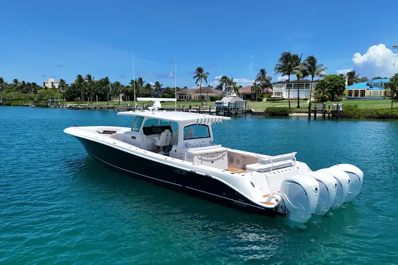 Slide: The Image of 2020 HCB 53 Sueños boat on clear blue water near luxury waterfront homes. - 3