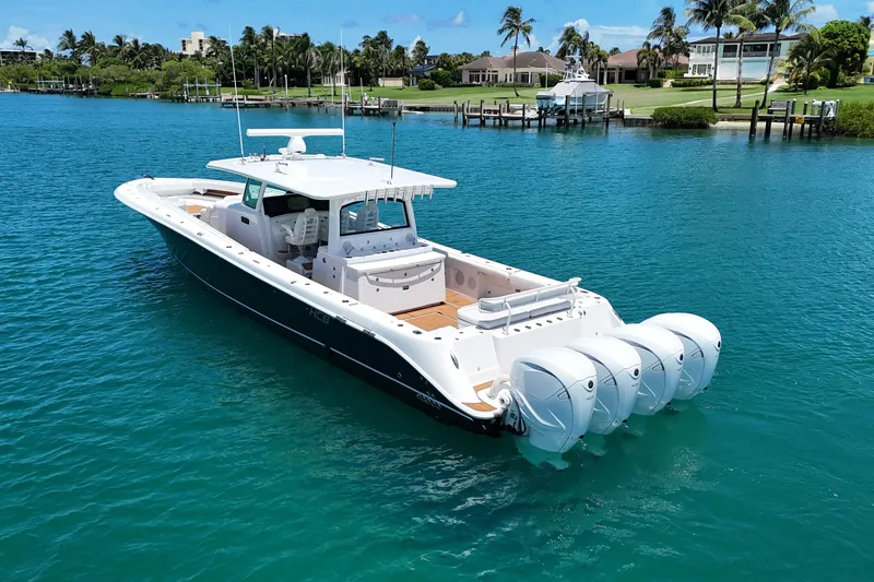 Slide: The Image of 2020 HCB 53 Sueños boat with four engines on turquoise water. - 6