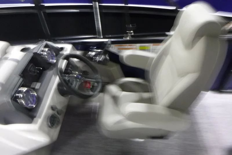 Slide: The Image of Blurry interior view of 2026 Premier 220 SUNSCAPE RL boat with steering wheel and seat. - 13
