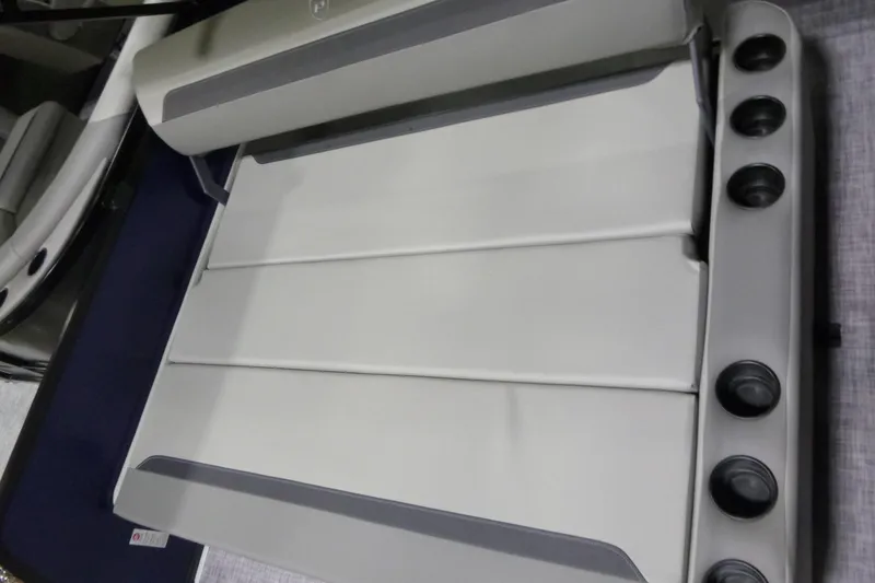 Slide: The Image of 2026 Premier 220 SUNSCAPE RL boat interior seating with cup holders, showcasing modern design. - 19