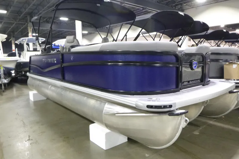 Slide: The Image of 2026 Premier 220 SUNSCAPE RL pontoon boat displayed indoors, featuring sleek design and modern amenities. - 3