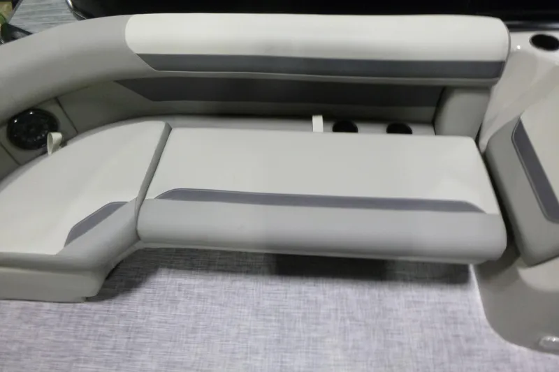 Slide: The Image of 2026 Premier 220 SUNSCAPE RL boat interior seating, featuring gray and white upholstery. - 7