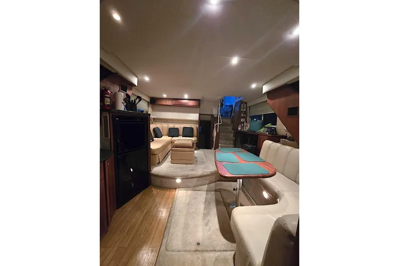 Slide: The Image of Luxurious interior of 2000 Silverton 392 Motor Yacht with plush seating and elegant dining area. - 10