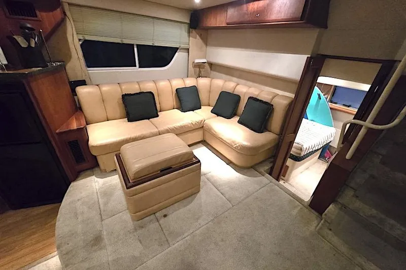 Slide: The Image of Luxurious interior of 2000 Silverton 392 Motor Yacht with beige seating and cozy cabin. - 11