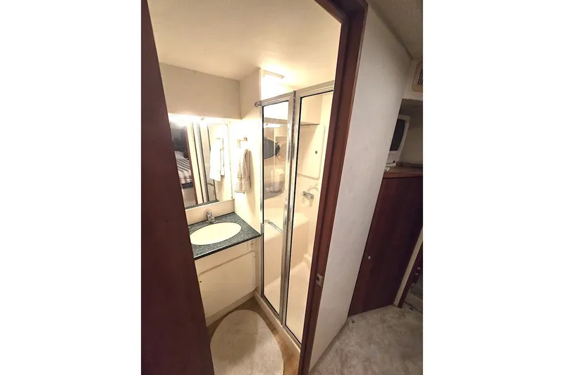 Slide: The Image of 2000 Silverton 392 Motor Yacht bathroom with shower, sink, and mirror. - 12
