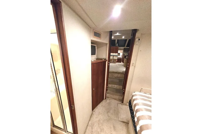 Slide: The Image of Interior of 2000 Silverton 392 Motor Yacht, featuring cozy cabin and hallway view. - 14