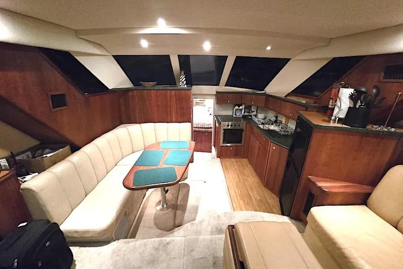 Slide: The Image of Interior of 2000 Silverton 392 Motor Yacht with cozy seating and modern kitchen amenities. - 15