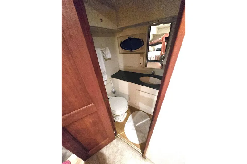 Slide: The Image of Bathroom interior of 2000 Silverton 392 Motor Yacht with sink and toilet. - 16