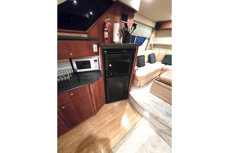 Slide: The Image of Interior of 2000 Silverton 392 Motor Yacht with kitchenette and seating area. - 3