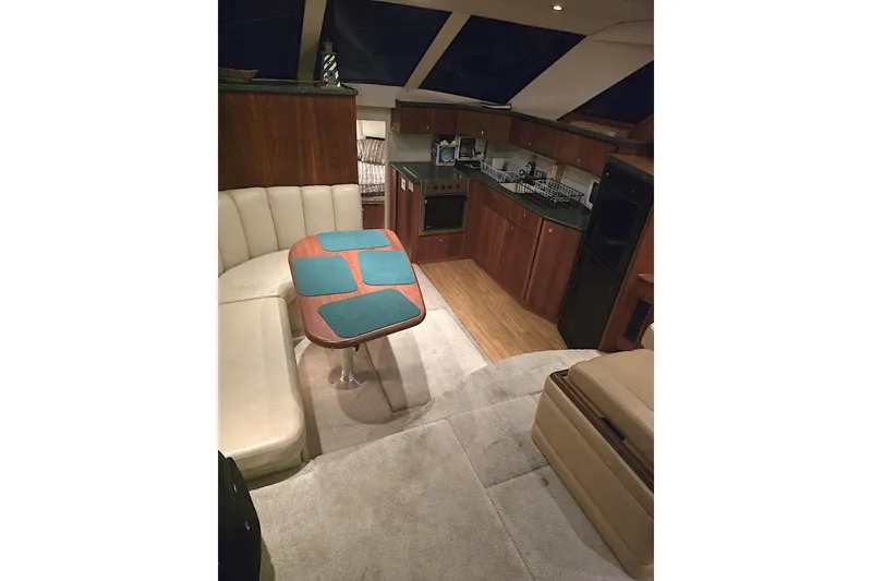 Slide: The Image of Interior of 2000 Silverton 392 Motor Yacht with kitchen and dining area. - 6