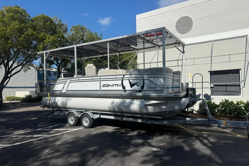 The Image of 2023 Starcraft SLS 3 Q DH pontoon boat on trailer, parked outdoors. - 0
