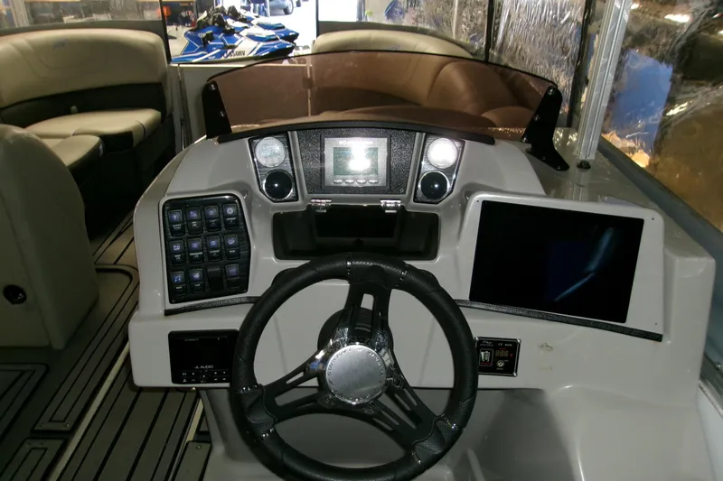 Slide: The Image of 2023 Starcraft SLS 3 Q DH boat dashboard with steering wheel and control panels. - 1