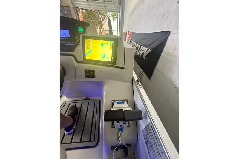 Slide: The Image of 2023 Starcraft SLS 3 Q DH boat dashboard with navigation display and controls. - 10