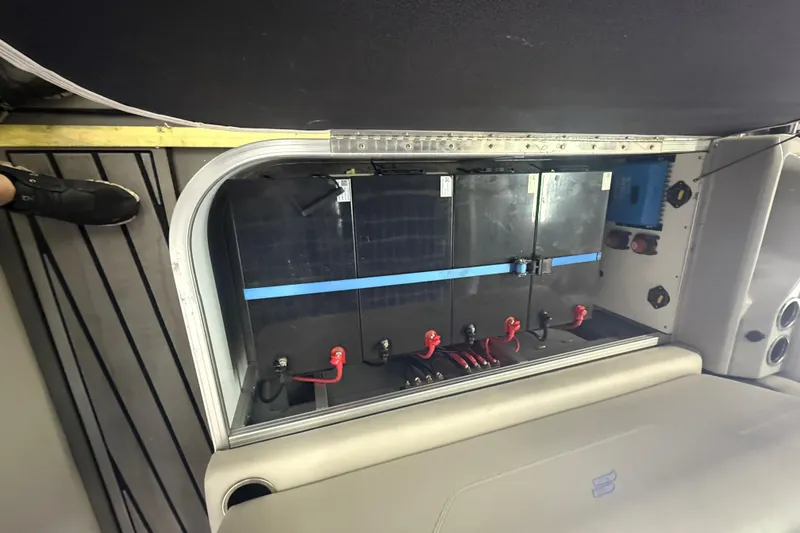 Slide: The Image of 2023 Starcraft SLS 3 Q DH battery compartment with secured wiring and components. - 12