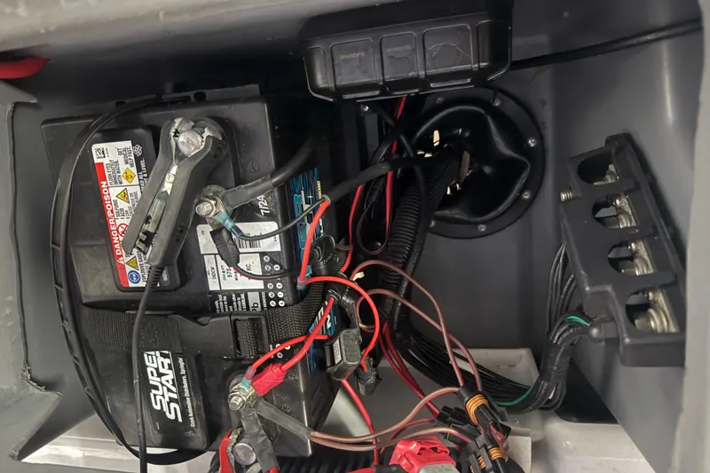 Slide: The Image of 2023 Starcraft SLS 3 Q DH boat battery compartment with wiring and connections. - 14