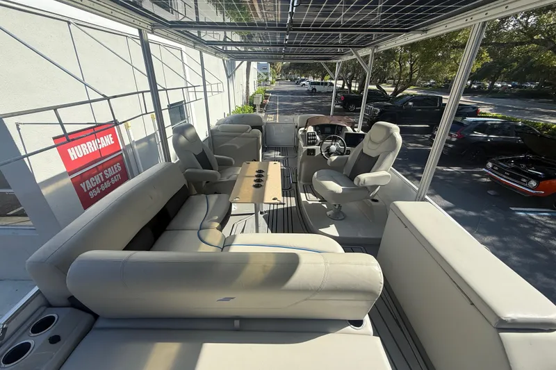 Slide: The Image of 2023 Starcraft SLS 3 Q DH pontoon boat interior with plush seating and steering console. - 17