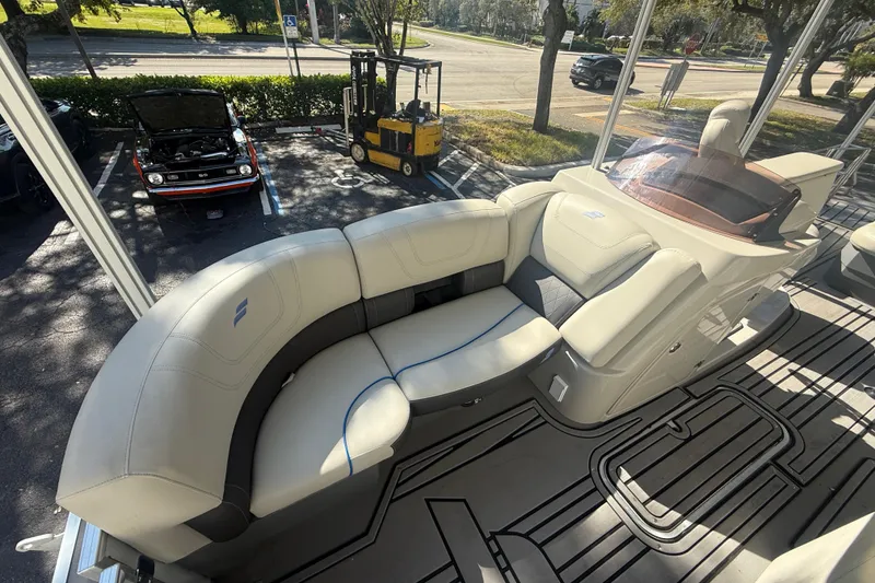 Slide: The Image of Luxurious seating on 2023 Starcraft SLS 3 Q DH boat, parked near classic car and forklift. - 18