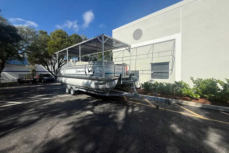 Slide: The Image of 2023 Starcraft SLS 3 Q DH pontoon boat on trailer, parked near building. - 26