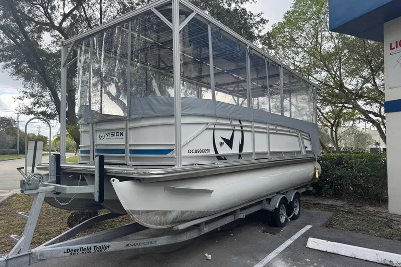 Slide: The Image of 2023 Starcraft SLS 3 Q DH pontoon boat on trailer, covered with transparent enclosure. - 4