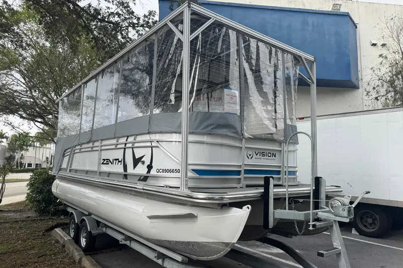 Slide: The Image of 2023 Starcraft SLS 3 Q DH pontoon boat with protective covering on a trailer. - 5