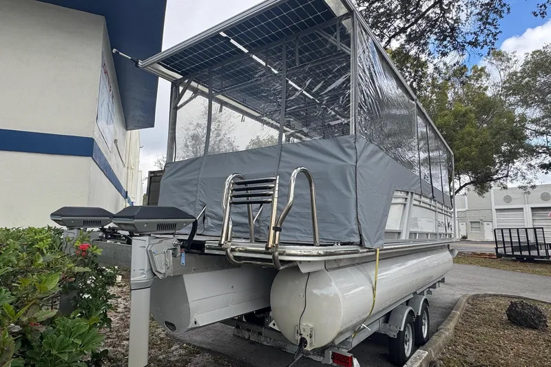 Slide: The Image of 2023 Starcraft SLS 3 Q DH pontoon boat with covered deck, parked outdoors. - 7