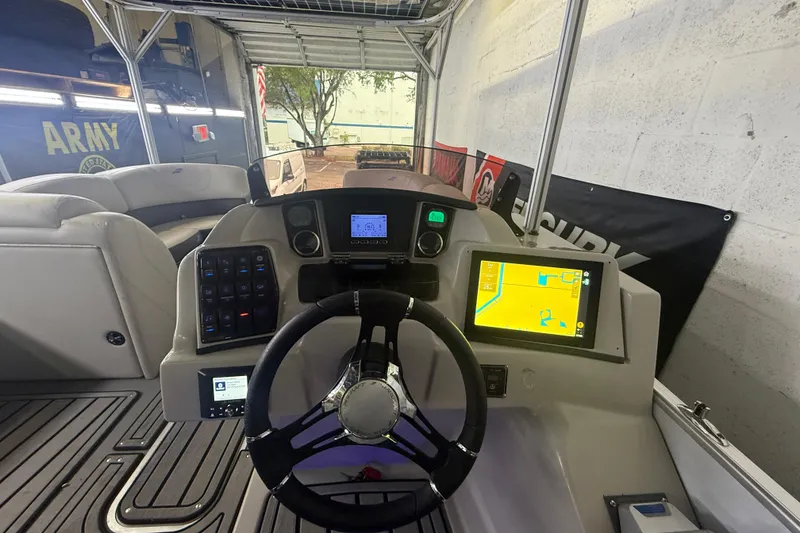 Slide: The Image of 2023 Starcraft SLS 3 Q DH boat dashboard with navigation system and controls. - 8