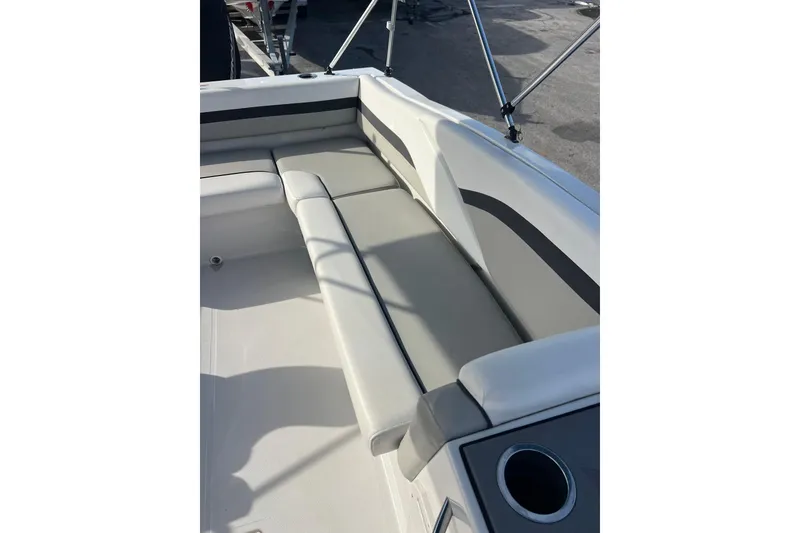 Slide: The Image of 2022 Starcraft SVX 191 OB boat interior with cushioned seating and cup holder. - 13
