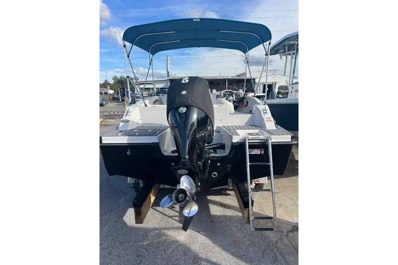 Slide: The Image of 2022 Starcraft SVX 191 OB boat with outboard motor and blue canopy. - 3